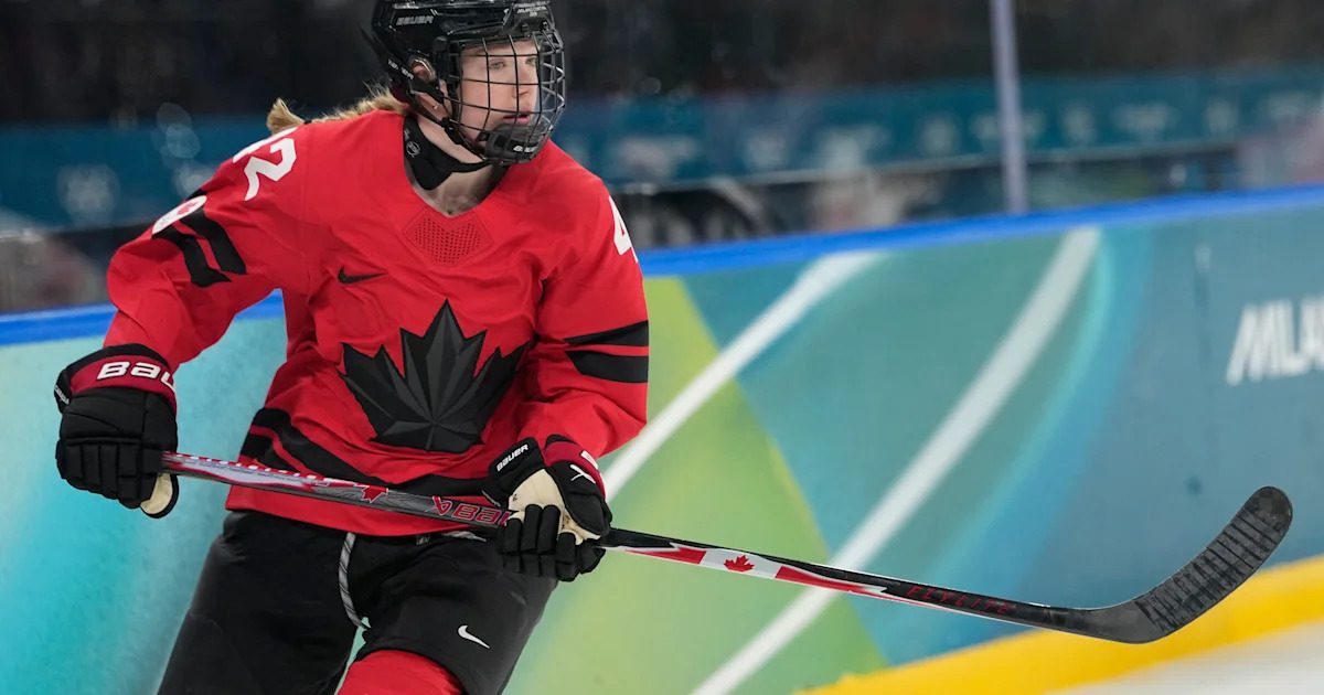 Professional hockey defender Claire Thompson skating on the ice during a game