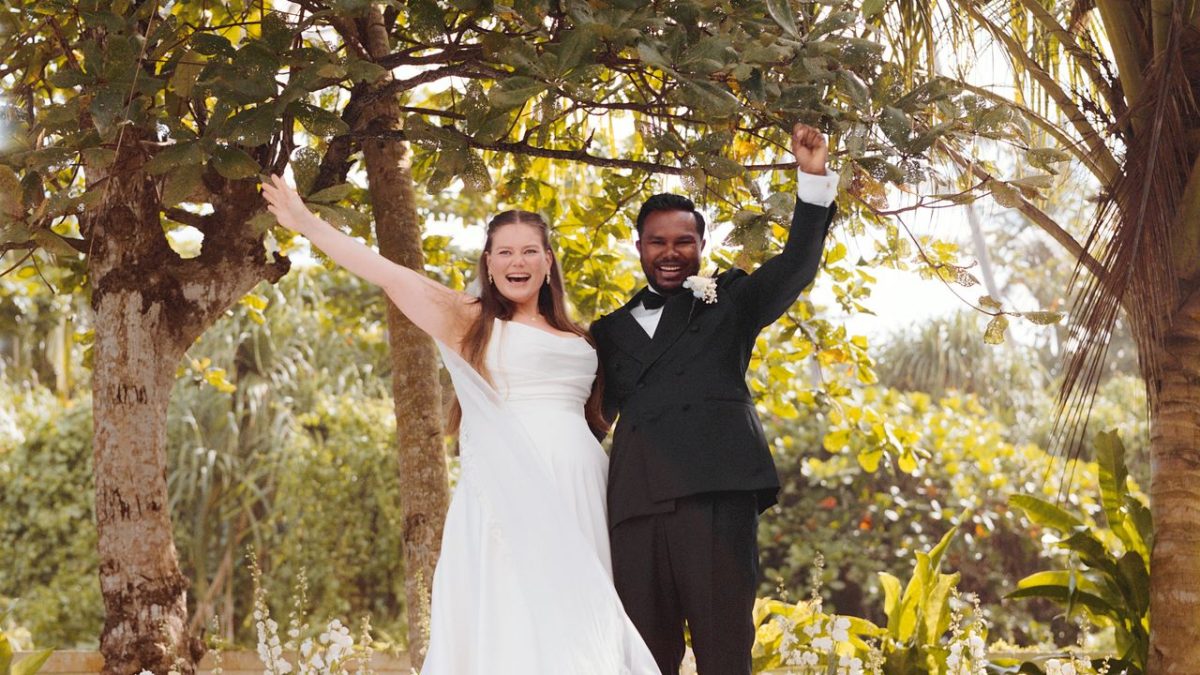 A bride and groom at a colorful outdoor wedding ceremony on a tropical Sri Lankan island