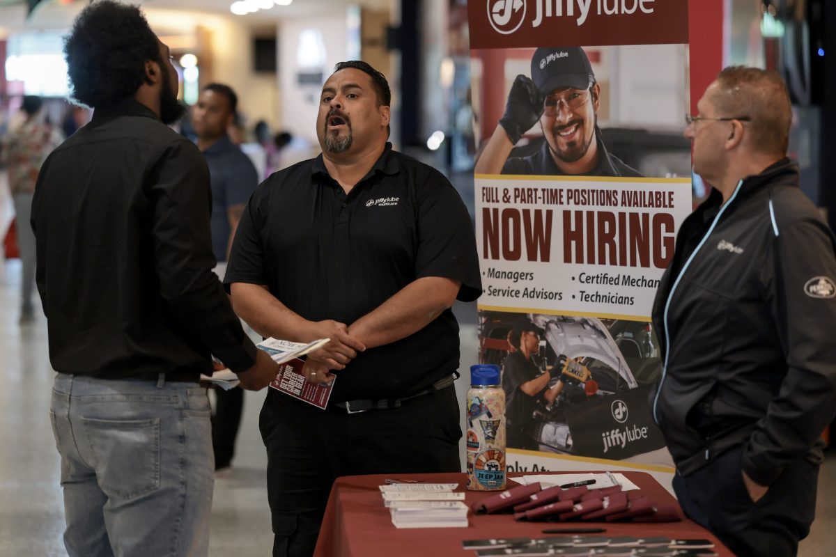 A hiring sign outside a retail storefront in the United States