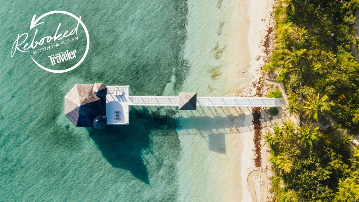 Aerial view of a private island resort surrounded by turquoise water in the Bahamas