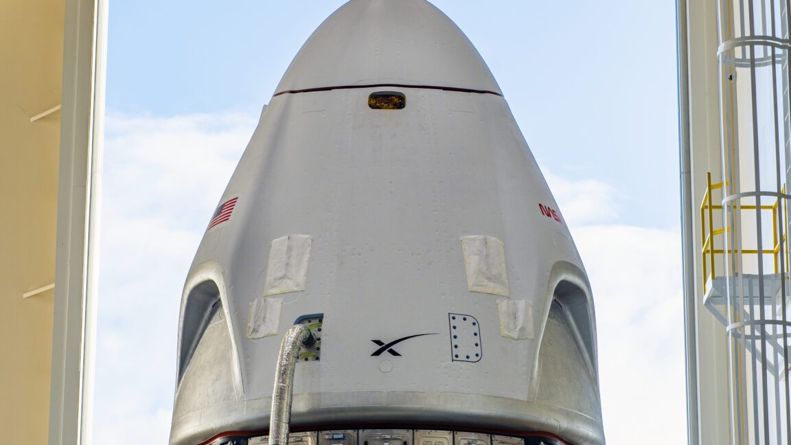 SpaceX Crew Dragon spacecraft stacked on Falcon 9 rocket at Kennedy Space Center pad