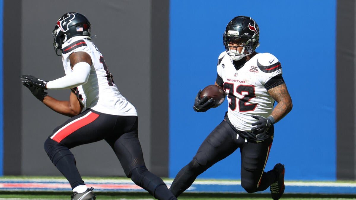 Fantasy football running back carrying the ball during an NFL game
