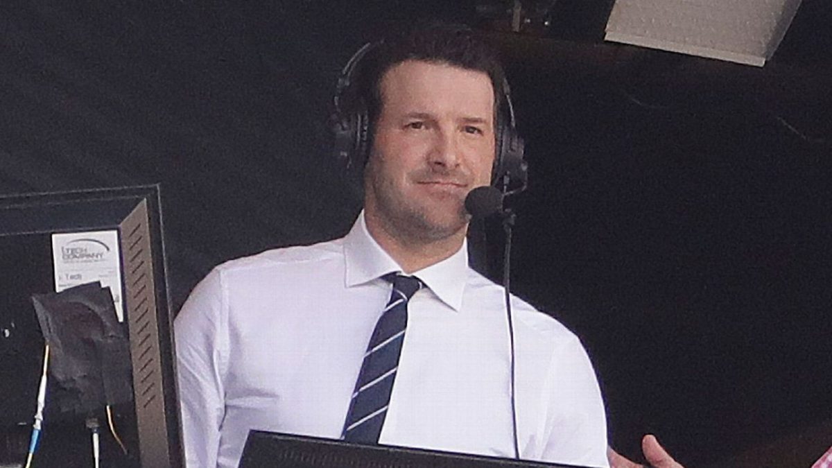 Tony Romo in a broadcast booth wearing a headset during an NFL game