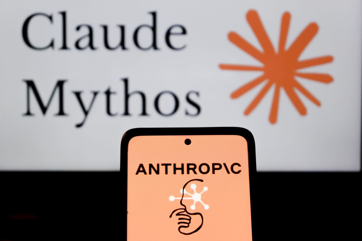 Anthropic logo displayed on a smartphone screen with code reflected in background