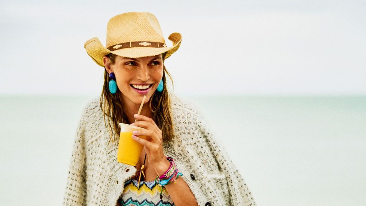 Gold accessories and resort fashion displayed against Florida Gulf Coast beach setting