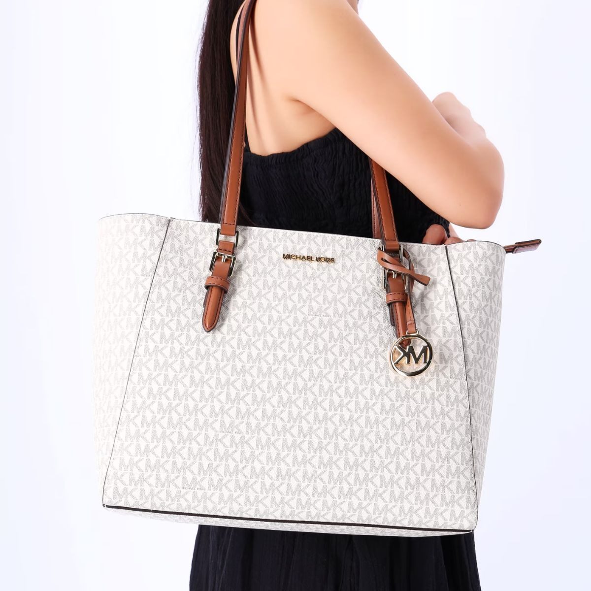 Michael Kors handbags displayed on shelves at a Walmart store during holiday shopping season