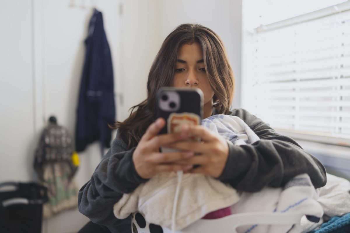 Smartphone displaying ChatGPT app with teen safety settings screen