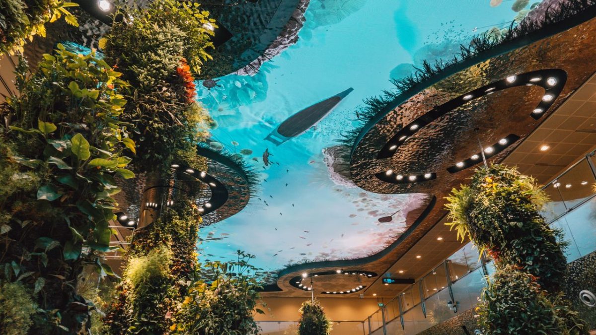 Travelers walking through Singapore Changi Airport's art-filled terminal